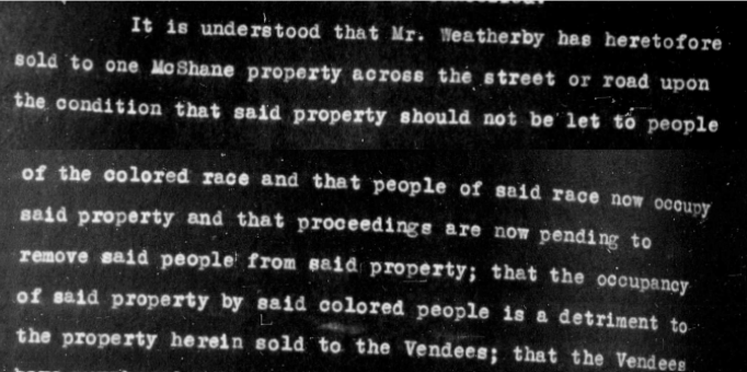 Part of a negative image of a property deed.